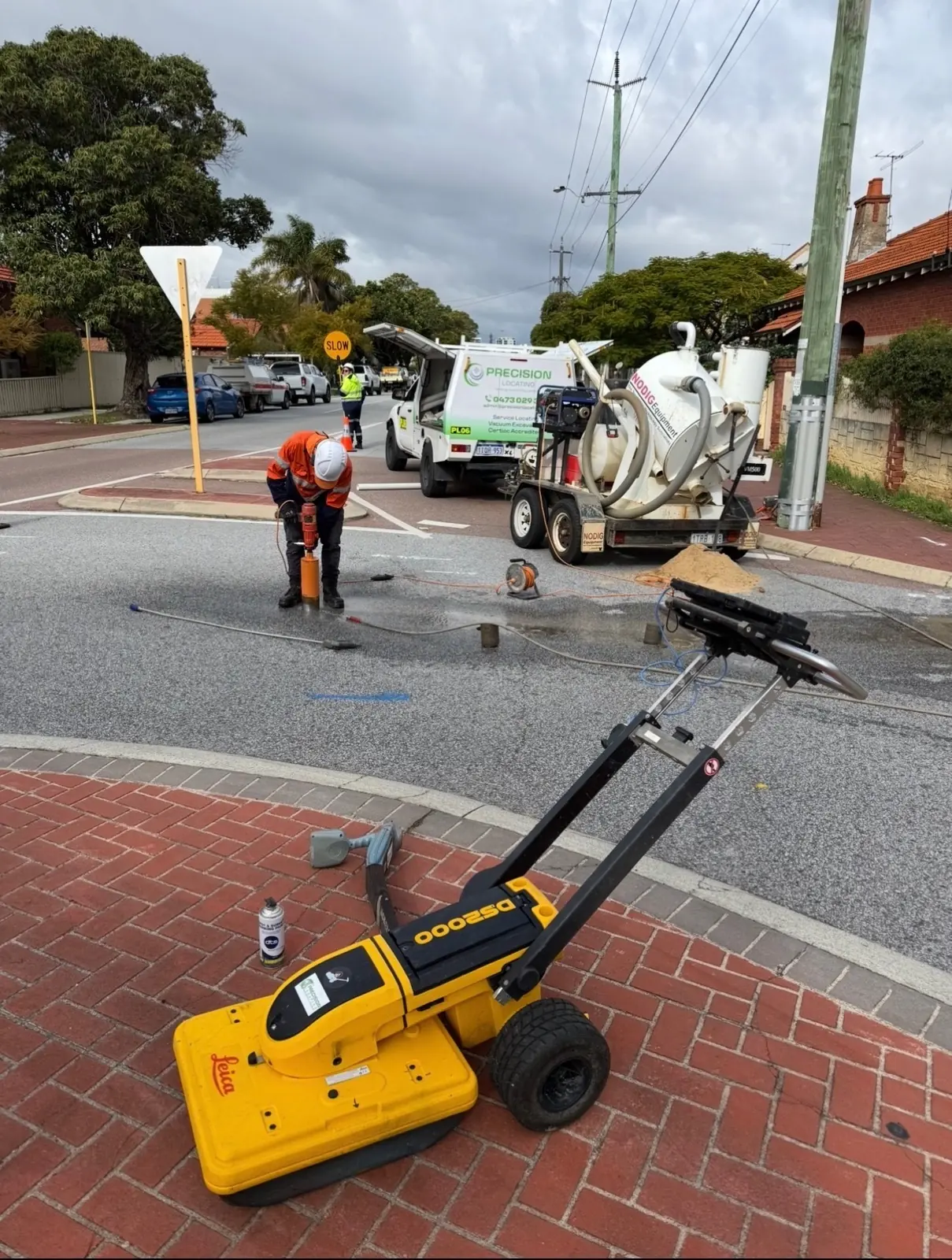 Precision Locating operator potholing beside GPR and vacuum excavation equipment