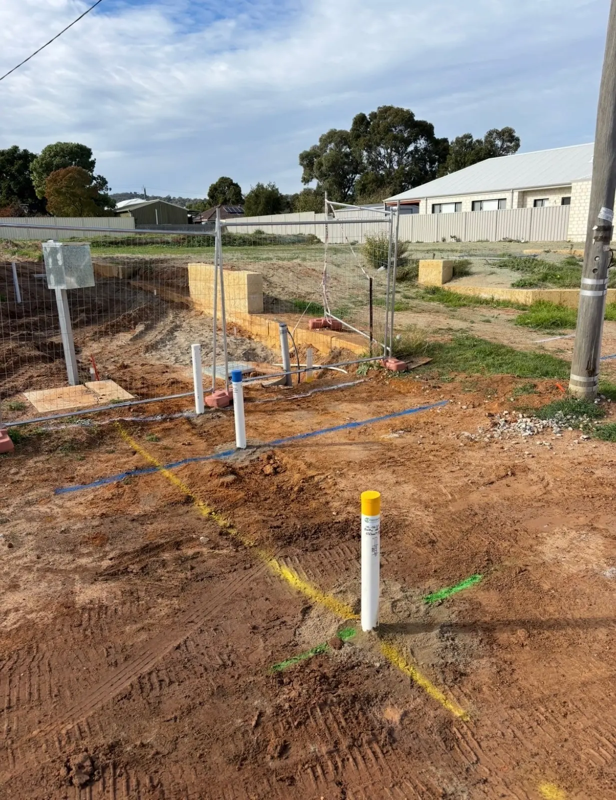 Underground services marked in coloured paint across a Perth construction site